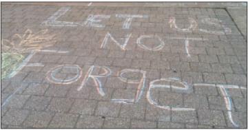 Chalked messages in front of the “Justice” Center in memory of Raul Pinet, Jr., who was killed there in August 2010. Photo: Barrie Gewanter.
