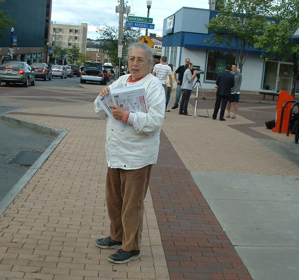 Rae distributing PNLs at the Parking Day.