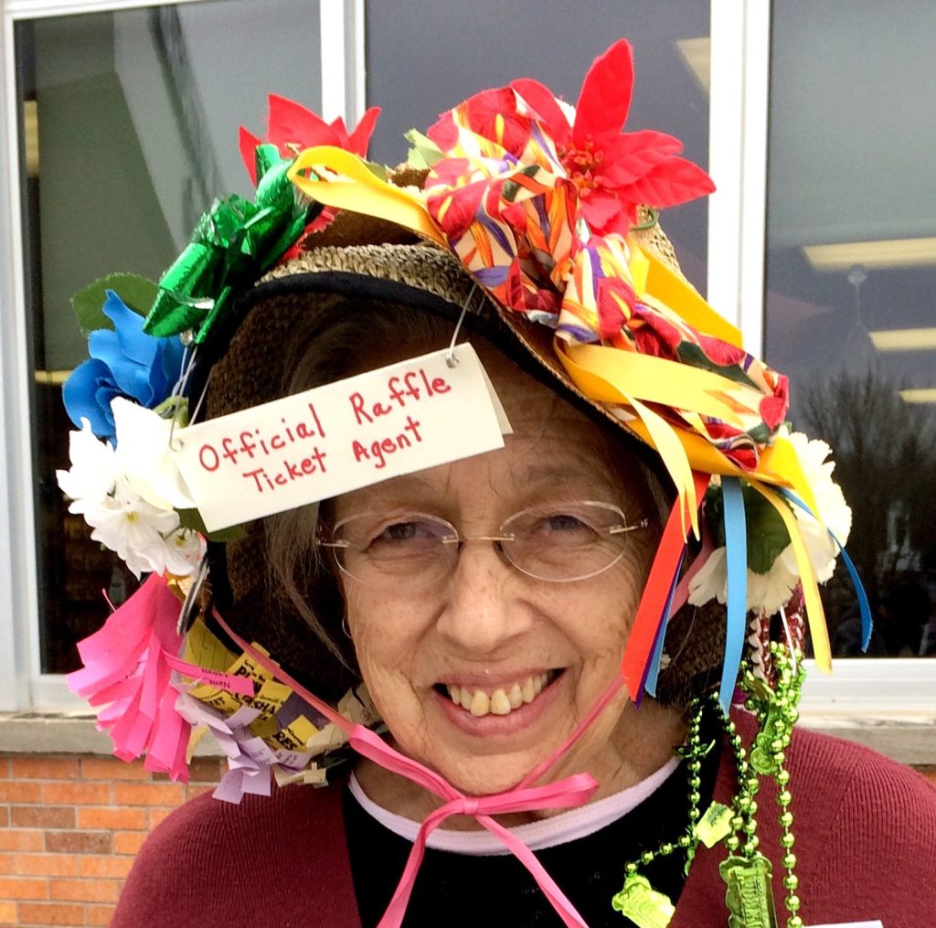 Rae Kramer, as the official Plowshares Craftsfair raffle ticket agent, in 2015.